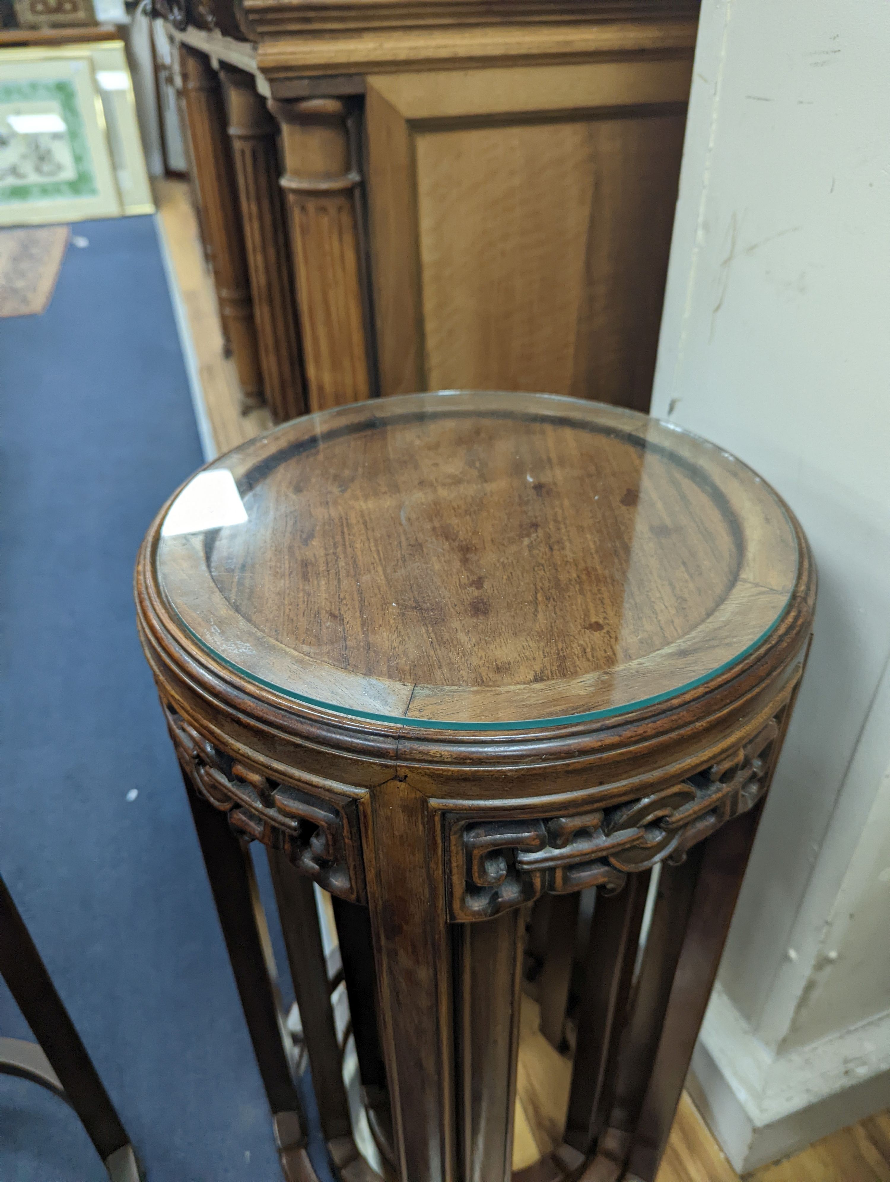 A nest of four Chinese hardwood circular tables, largest diameter 40cm, height 67cm